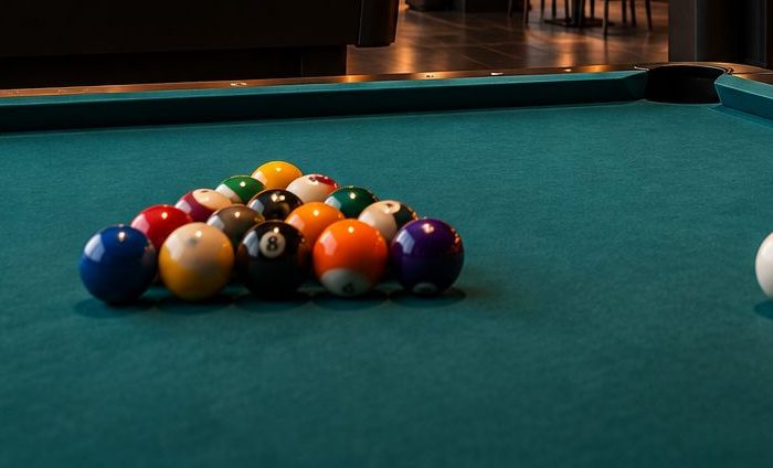 Racked pool balls on teal felt